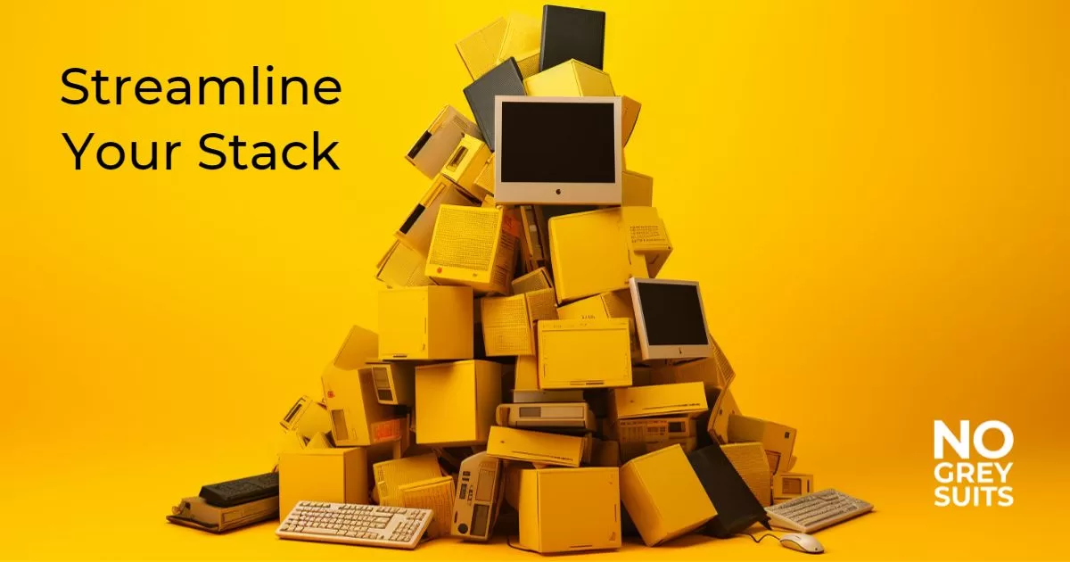 A haphazard stack of computers with heading Streamline Your Stack. The purpose of the image is to highlight a bunch of unnecessary tech items that could be streamlined, one way for a business owner to save money.